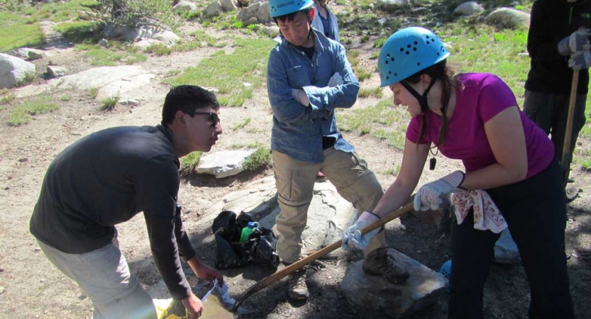 outward bound students use gardening tools during a service project